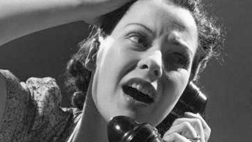 A female recruiter looking frustrated on the phone