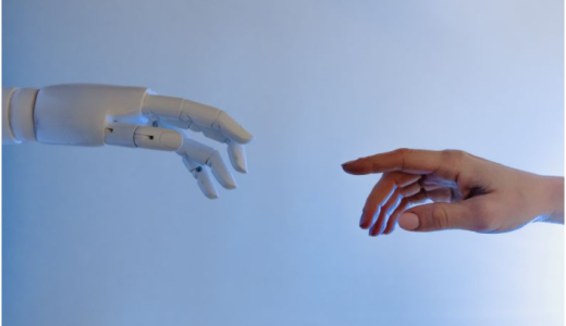 A human and a robot hand, reaching for each other