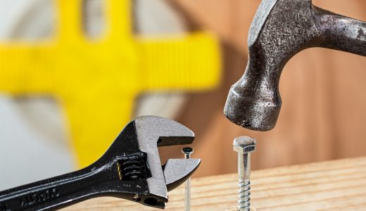 A spanner trying to turn a nail, and a hammer hammering in a screw